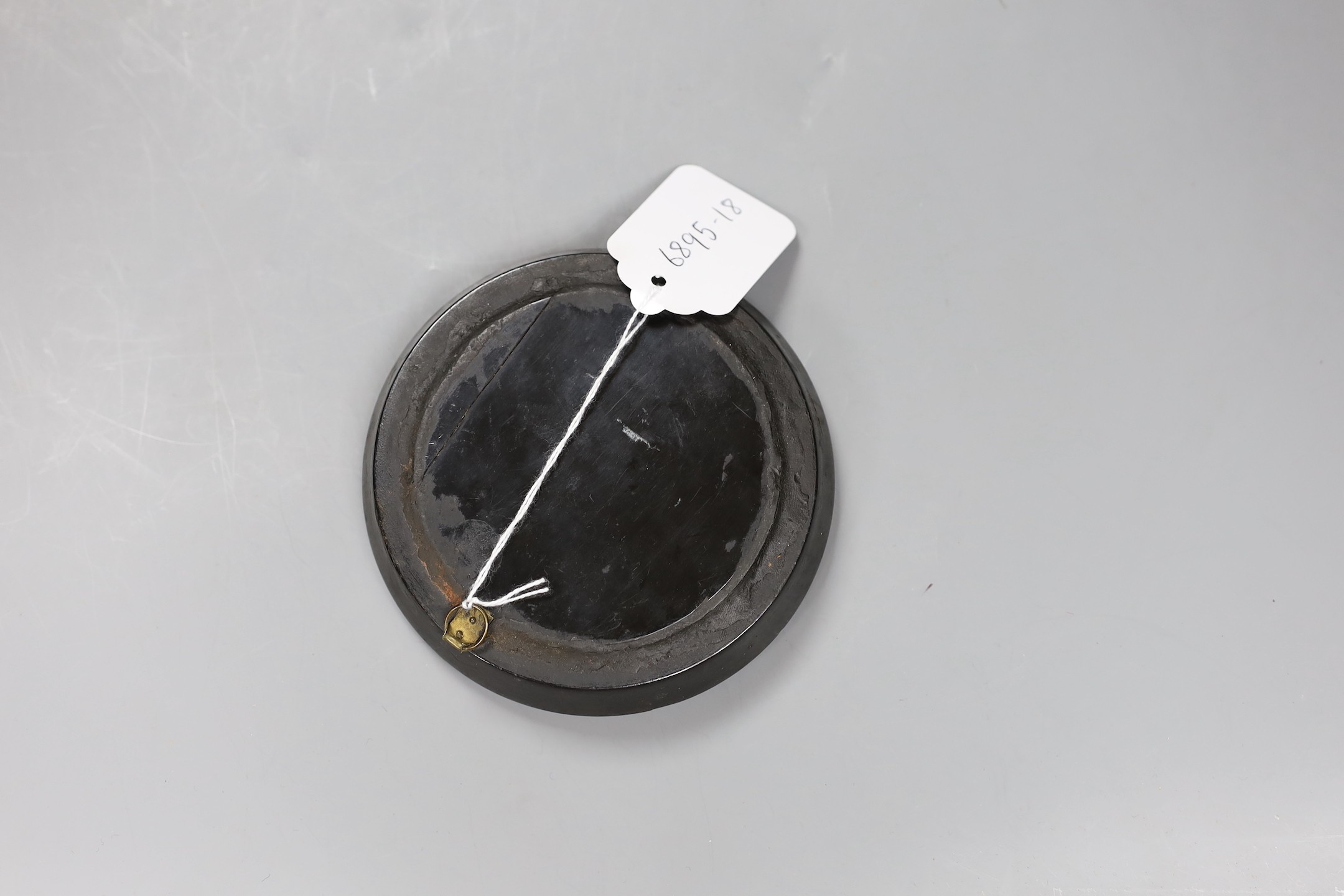 A 19th century painted snuff box lid panel (cut out), in a papier mache frame, 12cms diameter